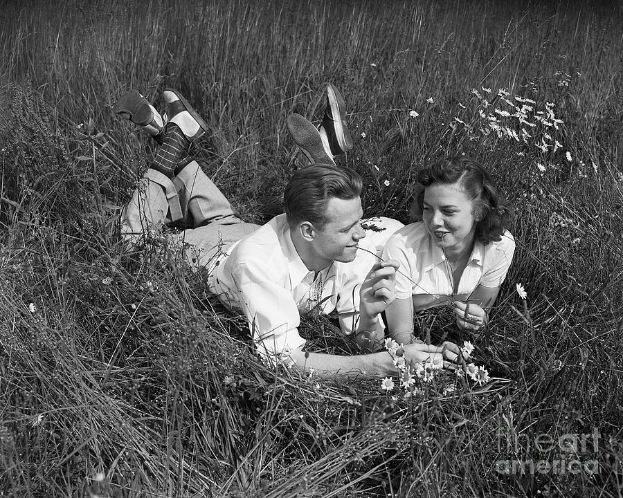 Young Couple Lying In The Grass Photograph by Bettmann
