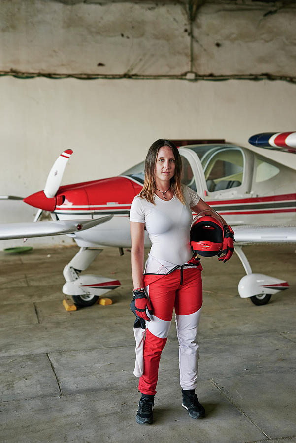 Daredevil Photograph - Young Female Skydiver In A Plane Hangar With A Helmet by Cavan Images