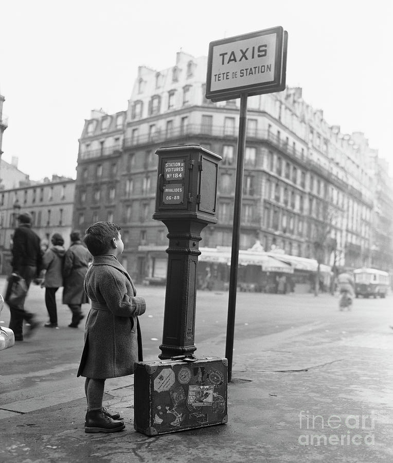Young French Boy Waiting For A Taxi Photograph by Bettmann