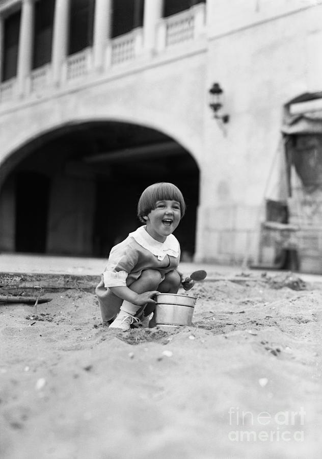 Young Girl 4-5 Years Playing In Sand Photograph by Bettmann