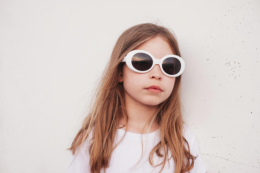 Young Girl Leaning Against Wall Outside Wearing Sunglasses Photograph 