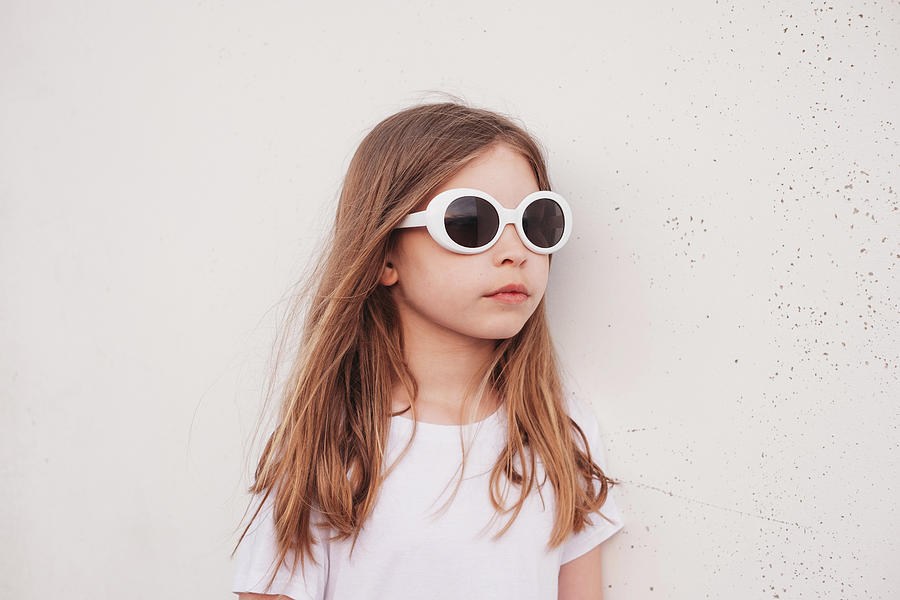 Young Girl Leaning Against Wall Wearing Sunglasses Outside Photograph ...