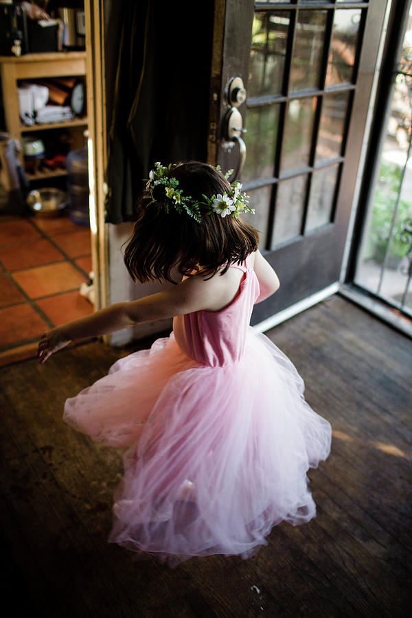 Butterfly Photograph - Young Girl Spinning By Front Door Wearing Tutu And Flower Crown by Cavan Images