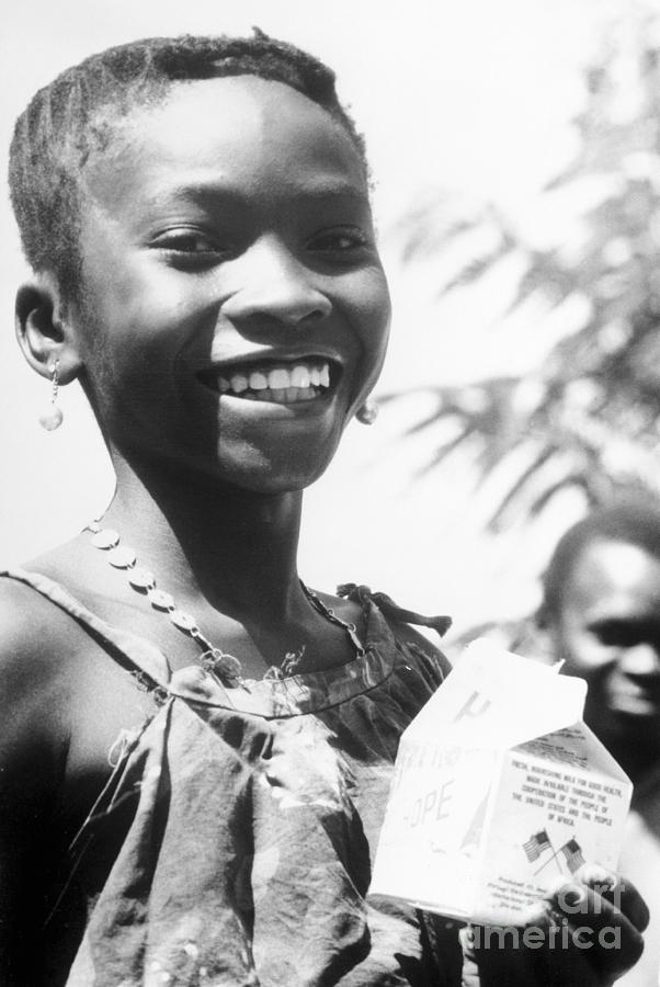 Young Guinea Child Holding Milk Photograph by Bettmann