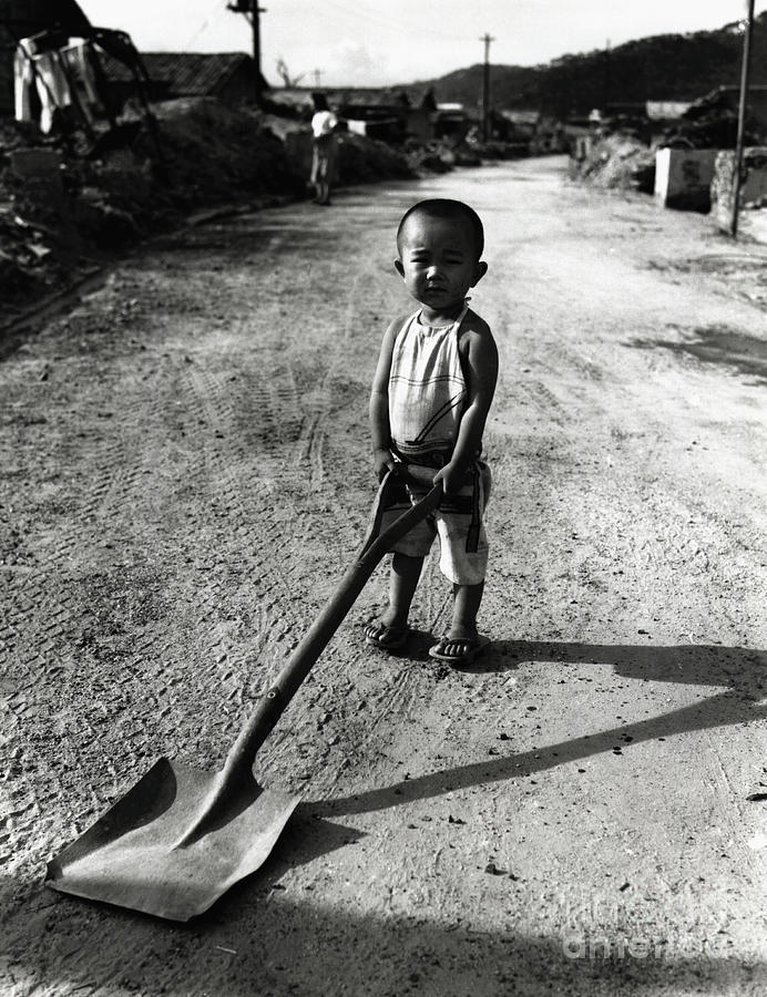 Young Japanese Boy Holding Shovel Photograph by Bettmann