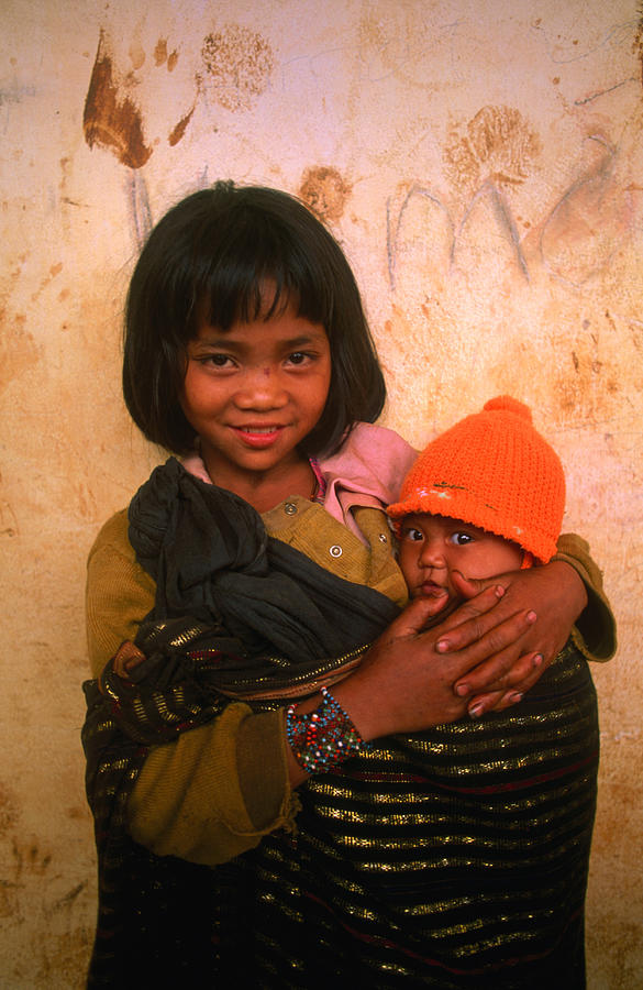 Young Koho Child Holding Baby At Photograph by John W Banagan