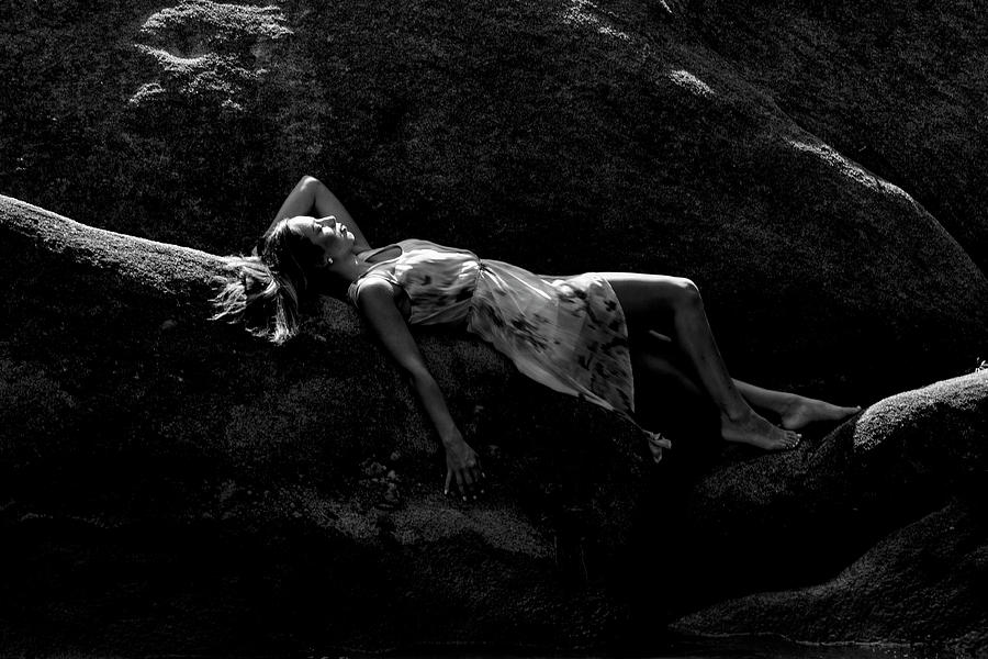 Young lady laying on a rock Photograph by Dan Friend