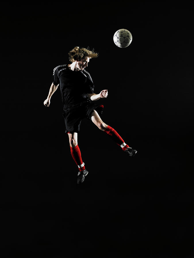 Young Man Heading Soccer Ball Photograph by Thomas Barwick