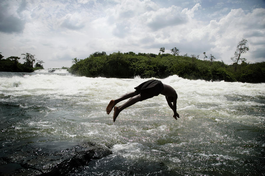 Young Man Jumping Into River Photograph by David Sacks