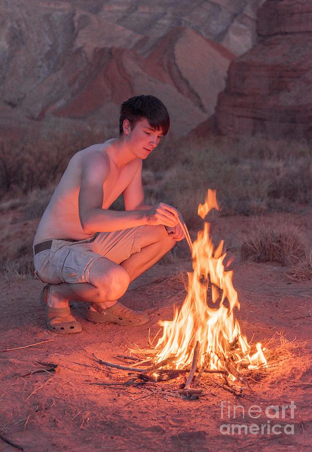 Young Man Lighting A Campfire Photograph by David Parker/science Photo Library