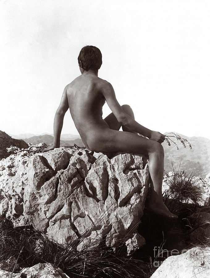 Young man posing on a rock Photograph by Wilhelm von Gloeden
