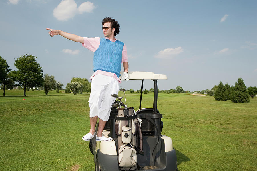 Young Man Standing On Golf Cart Photograph by Hollenderx2