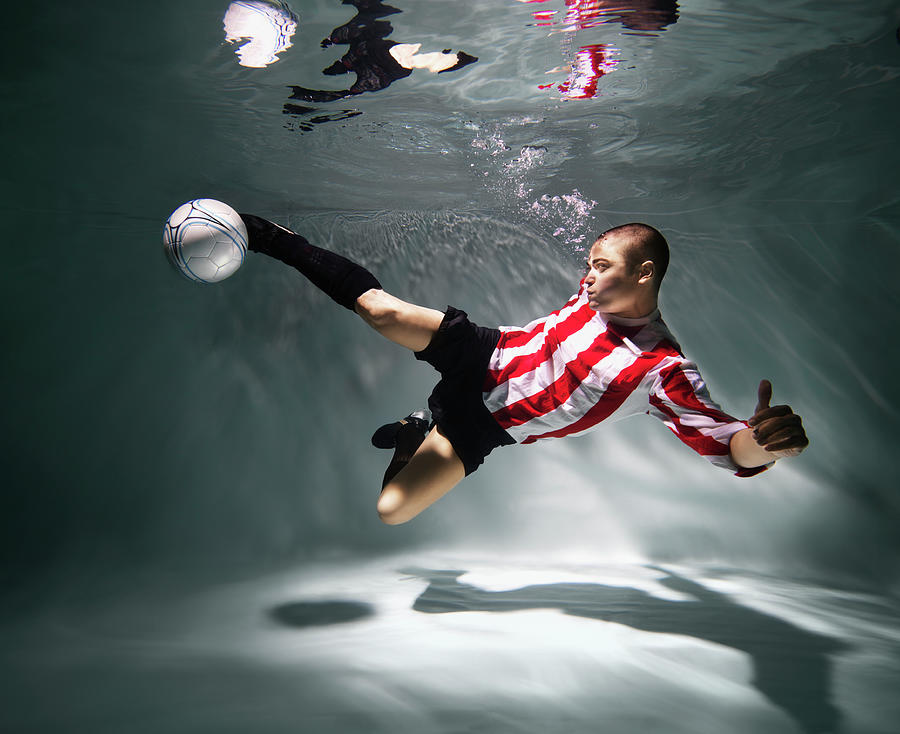 Young Man Underwater Playing Football Photograph by Henrik Sorensen