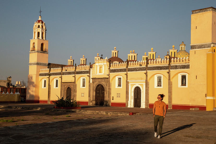 Capilla Real Photograph - Young Mexican Man Walking In Front Of Yellow Church In Cholula, Puebla by Cavan Images Capilla Real Photograph - Young Mexican Man Walking In Front Of Yellow Church In Cholula, Puebla by Cavan Images