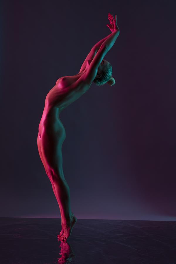 Young Naked Woman Dance Against Dark Purple Background Photograph by Andrey Guryanov
