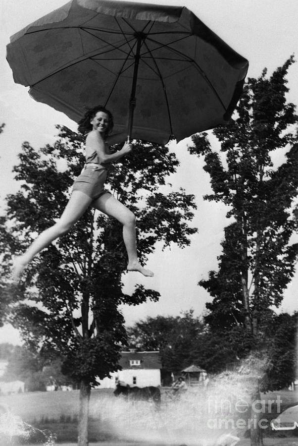 Young Smiling Woman Holding Umbrella Photograph by Bettmann