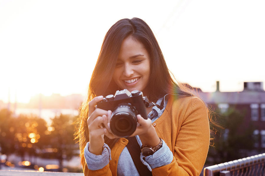 Young Woman Adjusting Camera Photograph by Cavan Images - Fine Art America