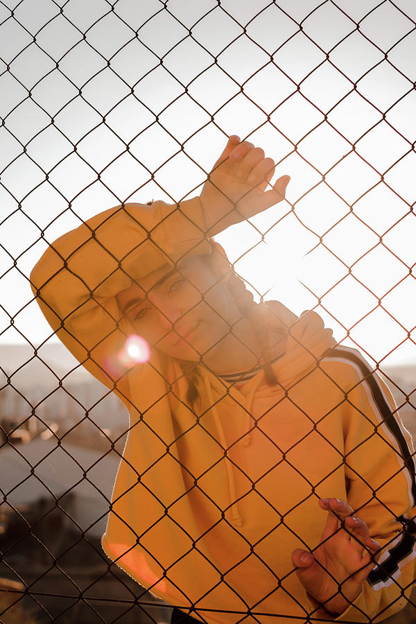 Summer Photograph - Young Woman Behind Bars On A Sunset by Cavan Images