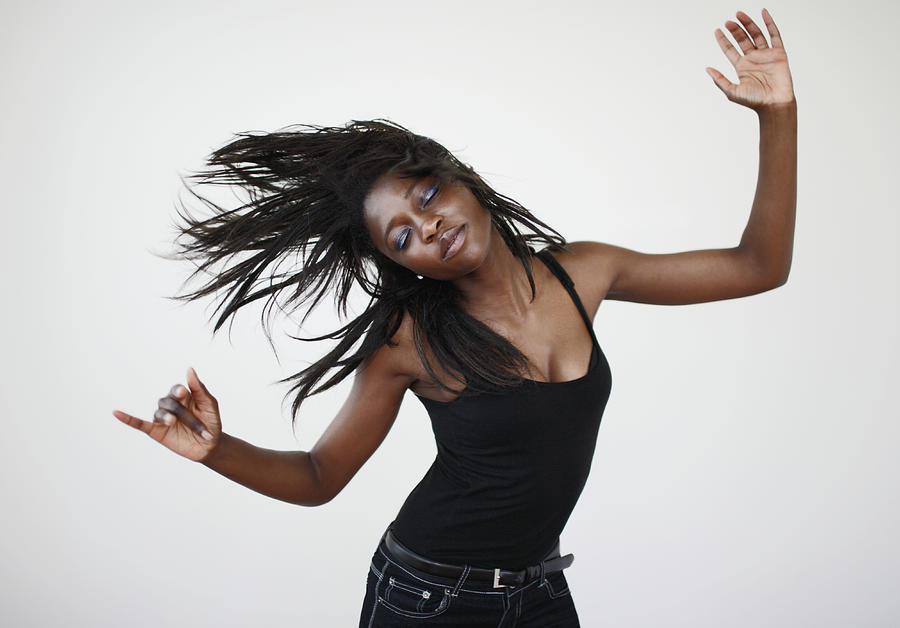 Young Woman Dancing And Shaking Her Hair Photograph by Darren Robb