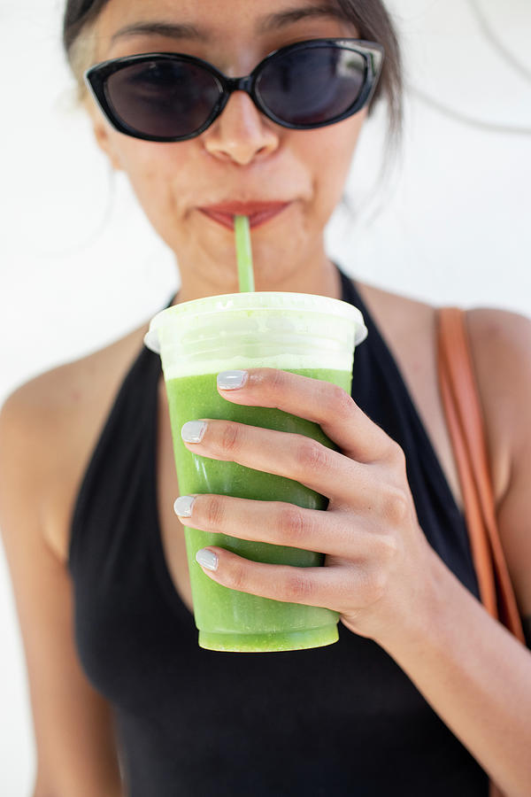 Young Woman Drinking Green Juice Photograph by Cavan Images - Fine Art ...