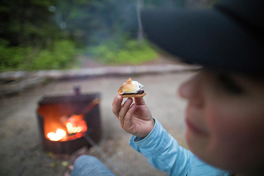 Winter Photograph - Young Woman Eating Smores Next To A Campfire. by Cavan Images