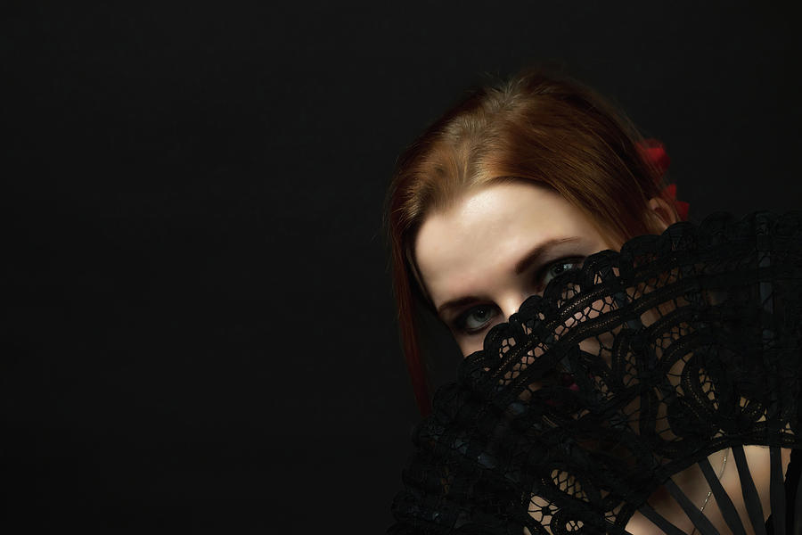 Young Woman Hiding Face By A Crochet Black Hand Fan Photograph