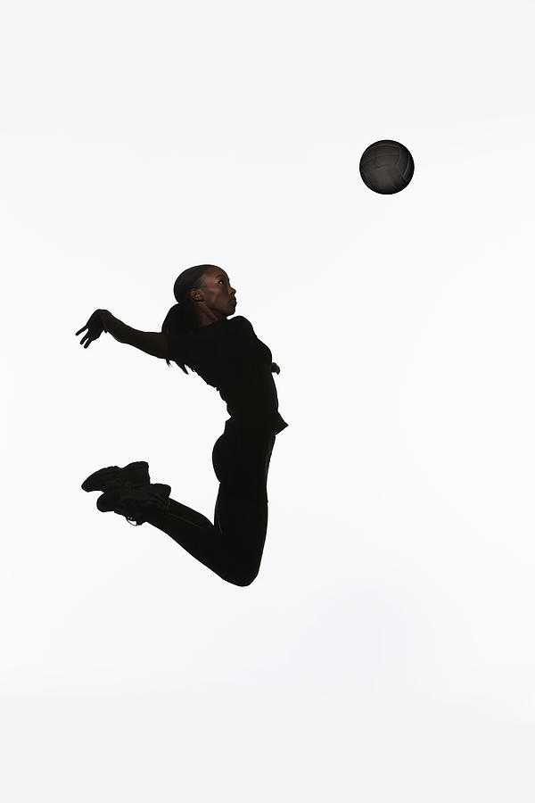 Young Woman Jumping In Air, Reaching To Photograph by Paul Taylor