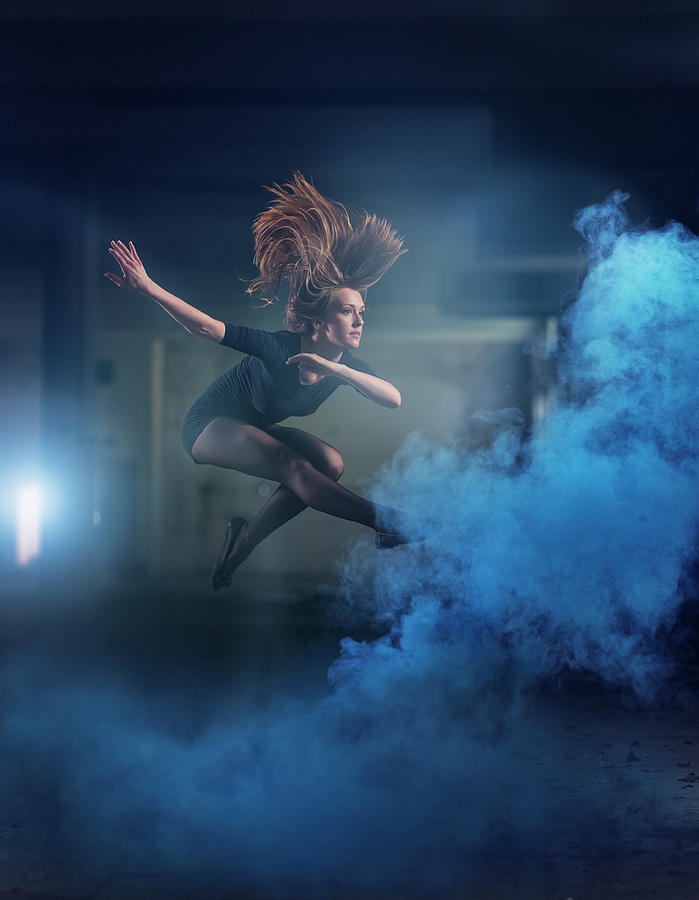 Young Woman Jumping In The Blue Fog Photograph by Matjaz Slanic