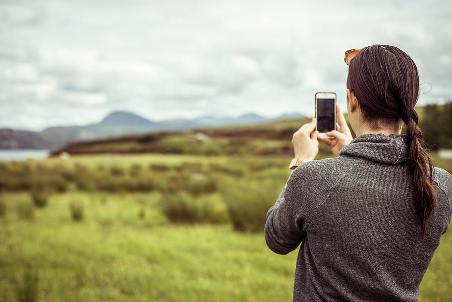 Young Woman Photographing Scottish Highlands Mountain Landscape