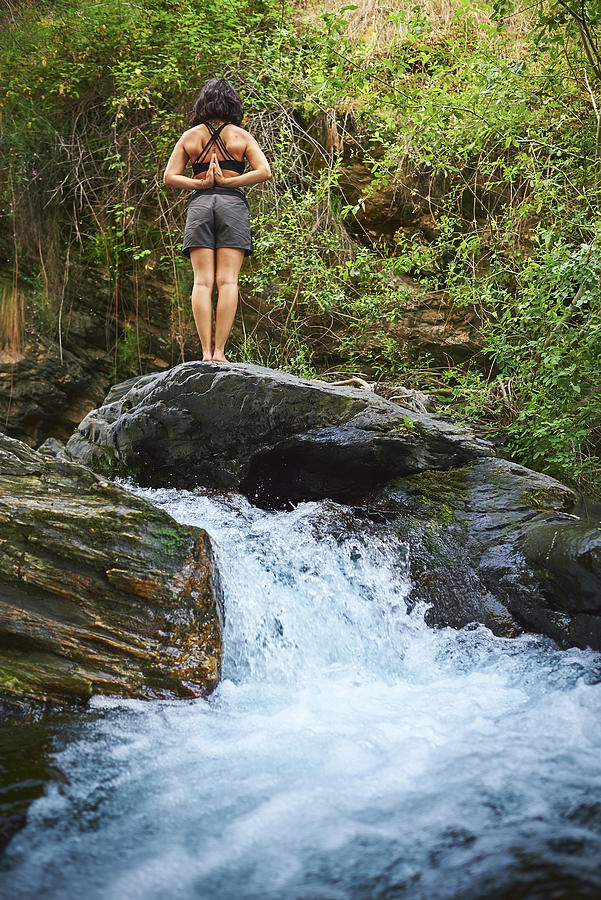 Nature Photograph - Young Woman Practicing Yoga In A River. by Cavan Images