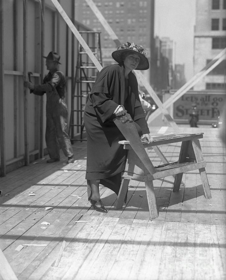 Young Woman Sawing Plank Photograph by Bettmann