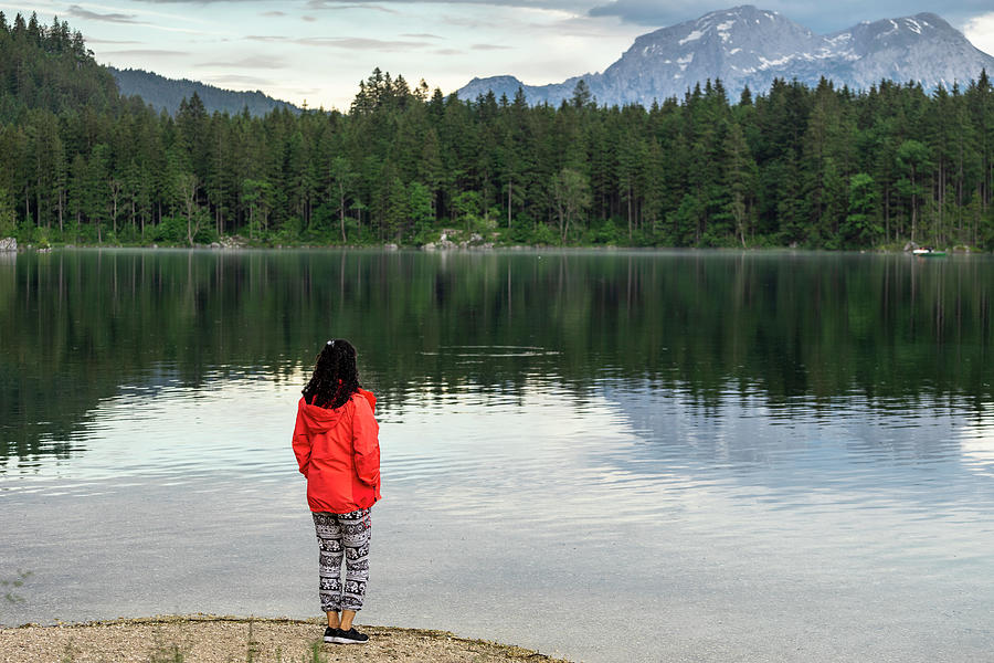 Young Woman Standing At A Mountain Lake And Enjoying The Landscape ...