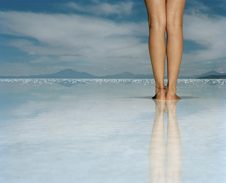 Young Woman Standing On Salt Flat, Low Photograph by Matthias Clamer