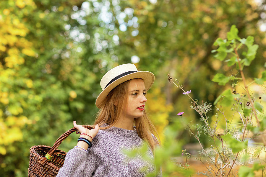 Tree Photograph - Young Woman With Blond Hair And Hat In An Urbanic Garden by Cavan Images