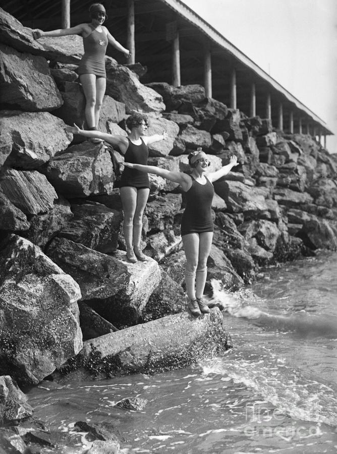 Young Women Standing On Coastline Photograph by Bettmann