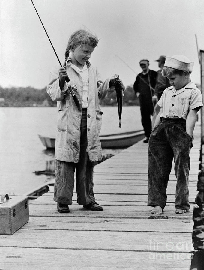 Youngster Displaying Catch On Dock Photograph by Bettmann