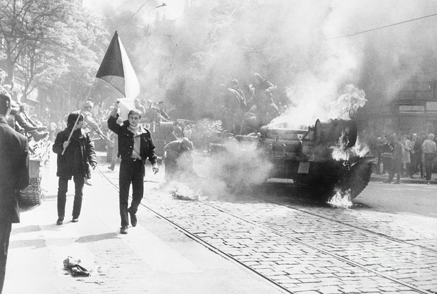 Youth Carry Flags Past Burning Tank Photograph by Bettmann