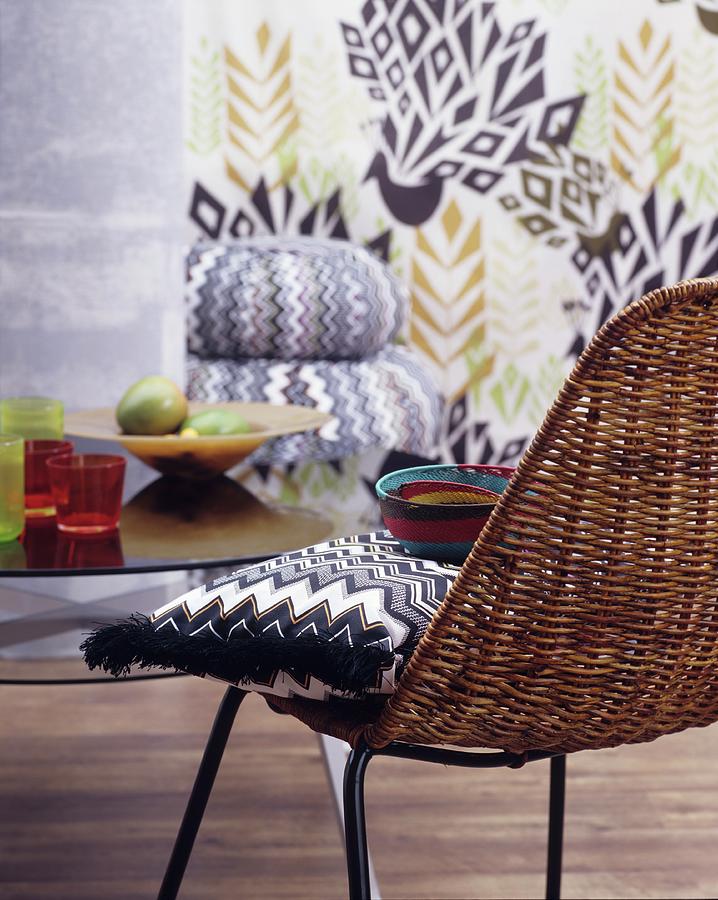 Pattern Photograph - Zigzag-patterned Cushion On Wicker Chair In Front Of Patterned Wall by Matteo Manduzio
