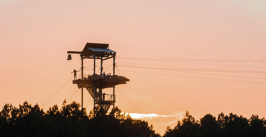 Zipline Tower With People Silhouettes At Sunset Photograph by Alex Grichenko