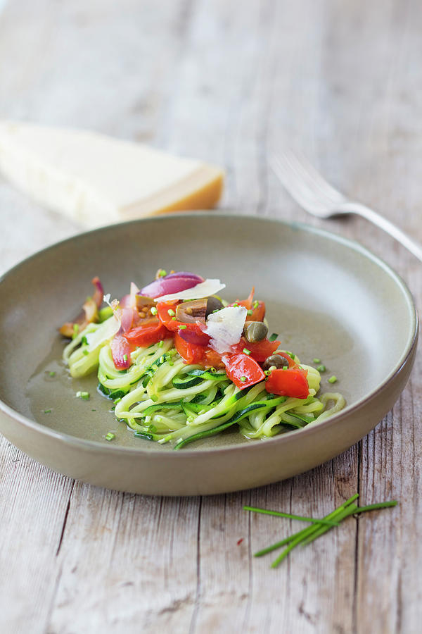 Zucchini Noodles With Tomatoes, Olives, Red Shallots And Capers Photograph by Jan Wischnewski