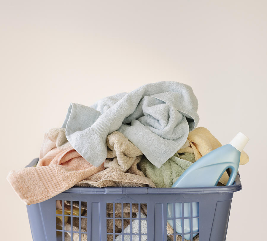 A laundry basket full of towels #1 Photograph by Tetra Images