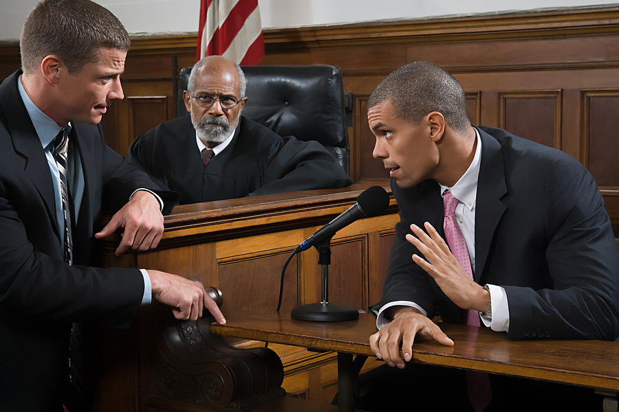 A lawyer questioning a suspect #1 Photograph by Image Source