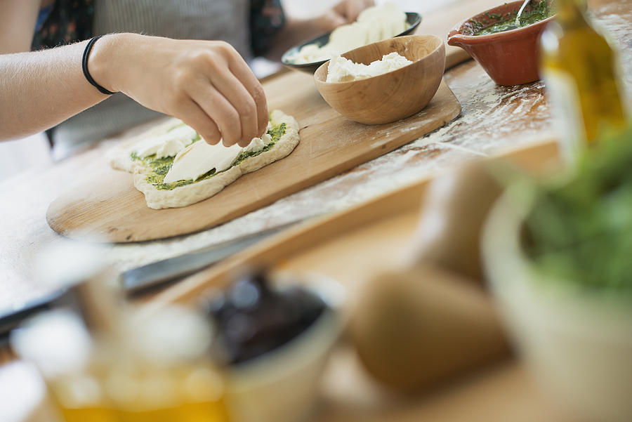 A person making a wrap with fresh ingredients and green salsa. #1 Photograph by Mint Images/  Tim Pannell