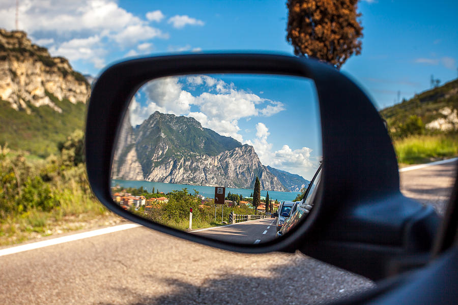 A reflection in a cars mirror at Lake Garda, Italy #1 Photograph by Kirill Rudenko