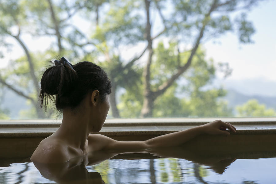 A Young BackLess Woman Bathing at Hot Spring Resort with Beautiful Landscape View #1 Photograph by Ivan