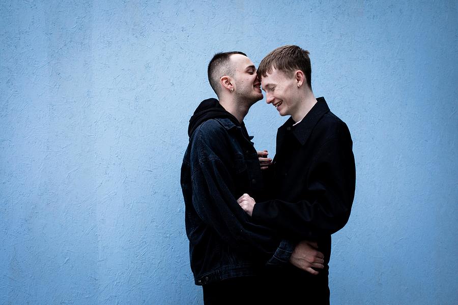 A young LGBT couple laughing and hugging #1 Photograph by Sophie Mayanne
