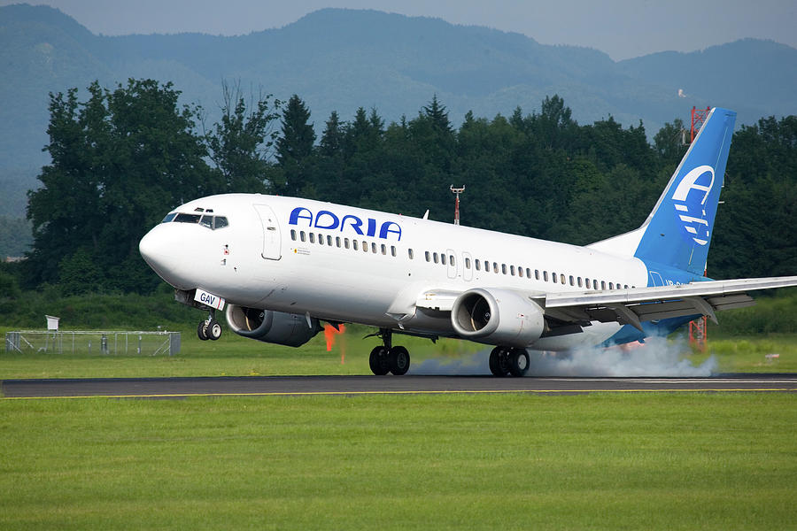 Adria aircraft landing at Ljubljana Joze Pucnik Airport #1 Photograph by Ian Middleton