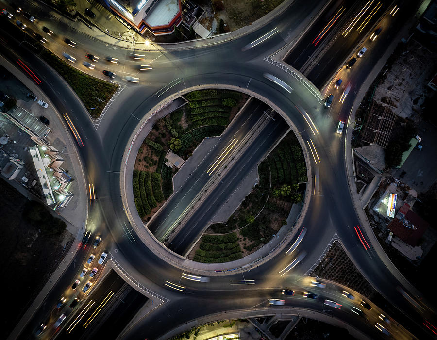 Aerial drone top view of a modern motorway junction roundabout with cars moving. Transportation infrastructure, #1 Photograph by Michalakis Ppalis