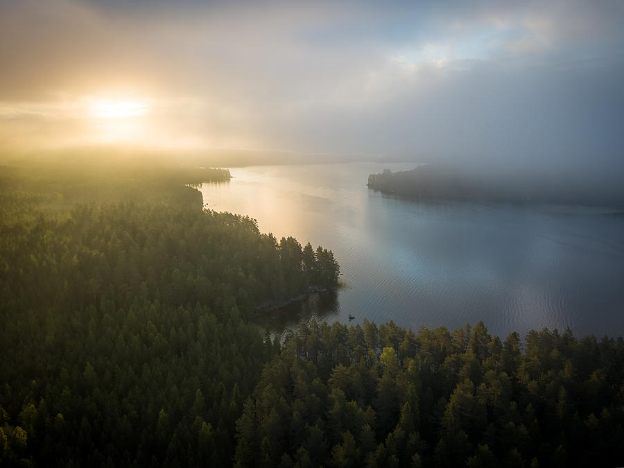 Aerial view of a misty forest & lake landscape in Finland during sunrise early on a summer morning #1 Photograph by Miemo Penttinen - miemo.net