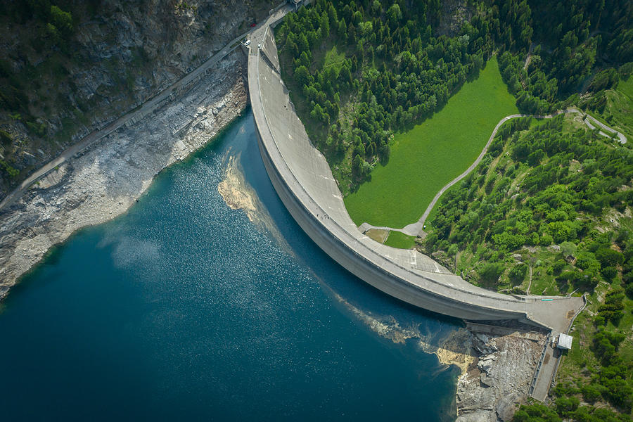 Aerial view of bridge on large dam in Swiss Alps #1 Photograph by AscentXmedia